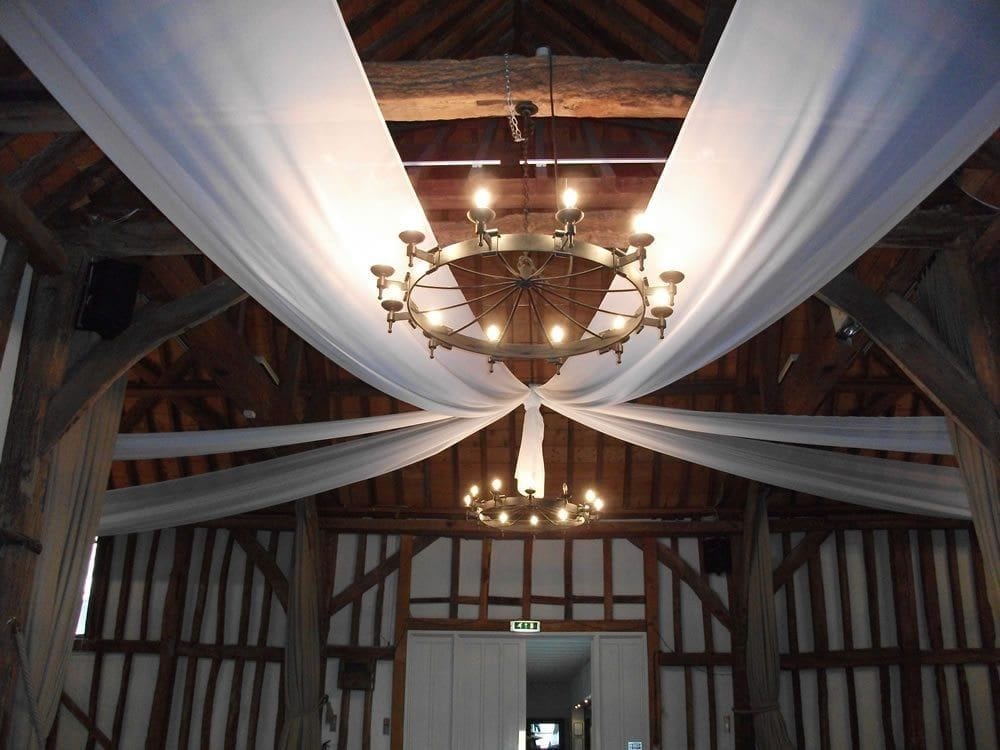 Chandelier with white drapes on the ceiling