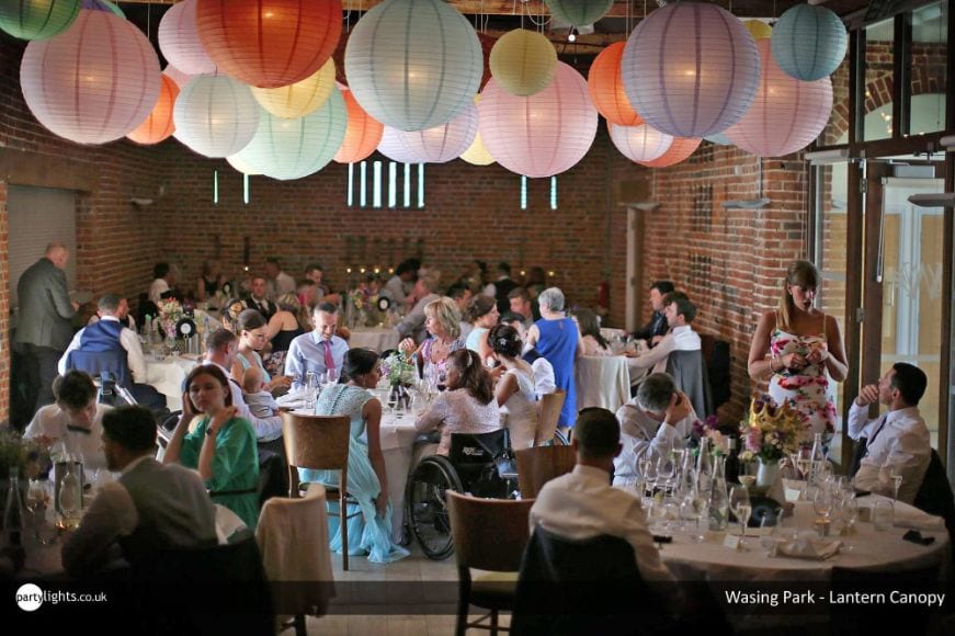 Wedding venue decorated with pastel hanging lantern canopy