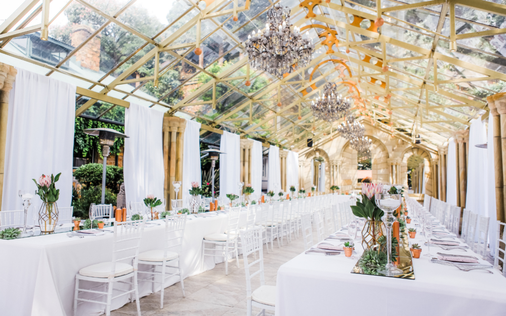 wedding reception indoor with classic chandeliers hanging for the ceiling