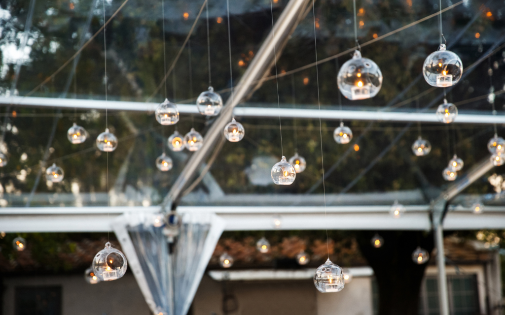 candle lit lanterns hanging from the ceiling