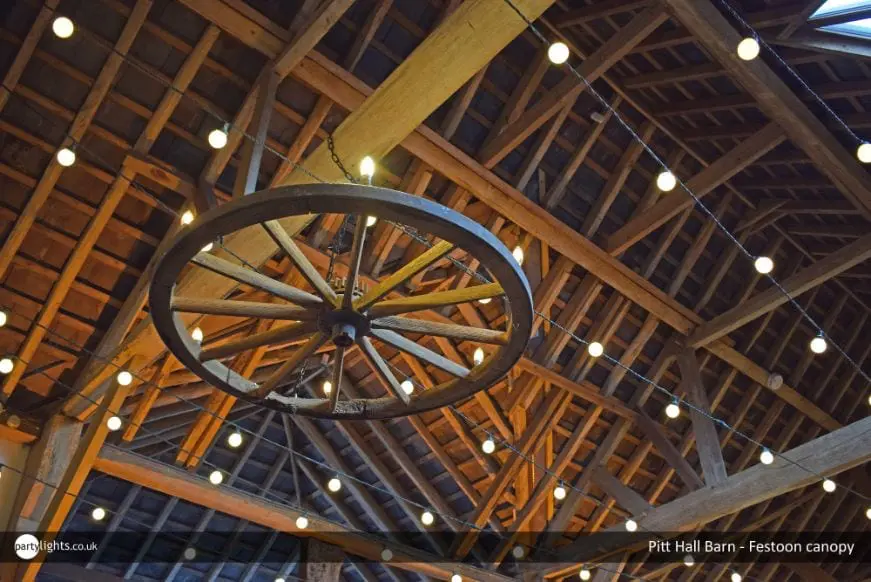 Light bulb canopies decorating a barn interior