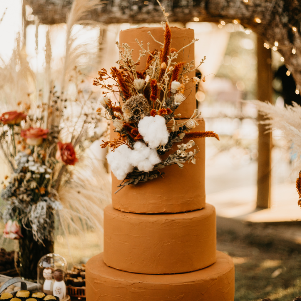 dark brown wedding cake with flowers with 4 tiers