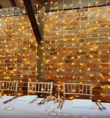 Lighting over exposed brick in wedding venue