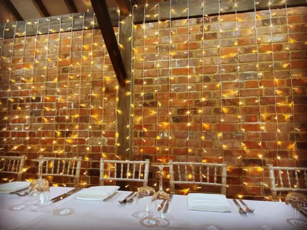 Lighting over exposed brick in wedding venue