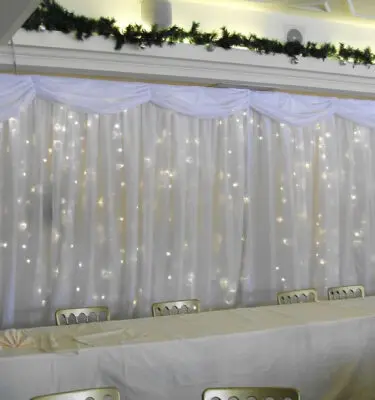 Light curtain behind bride and groom