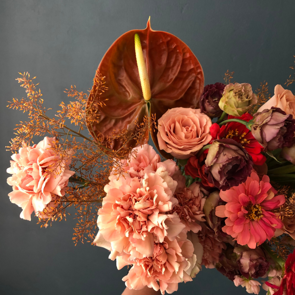 wedding flowers with different textures but similar colour of orange and red