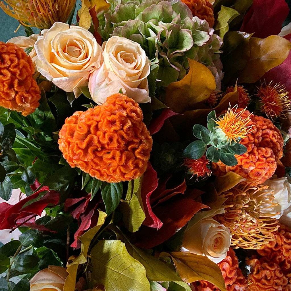 personalised wedding flower arrangement with orange and pink flowers