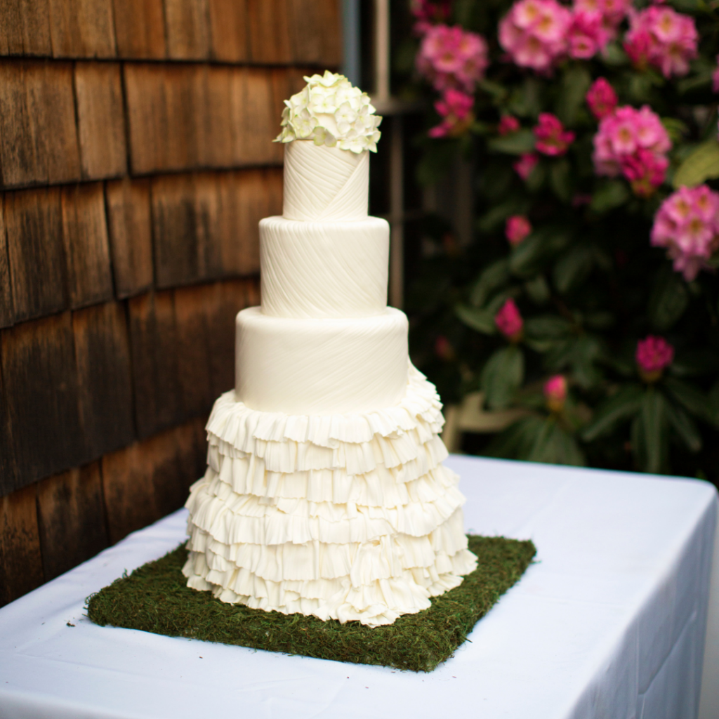 white ruffled wedding cake with 4 tiers