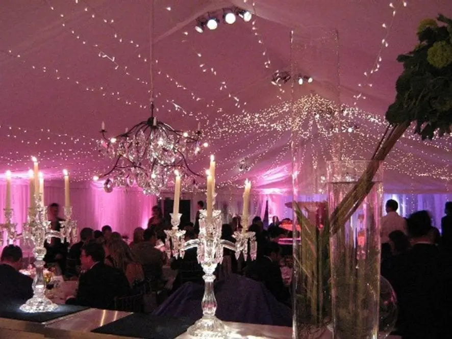 Wedding venue lit up with pink lights and draping fairy lights