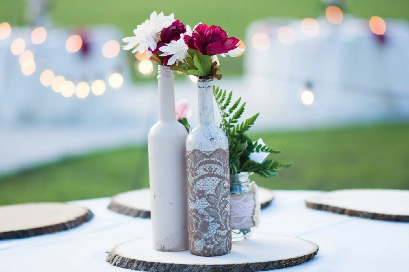 Close up of bottle vases with flowers in. 