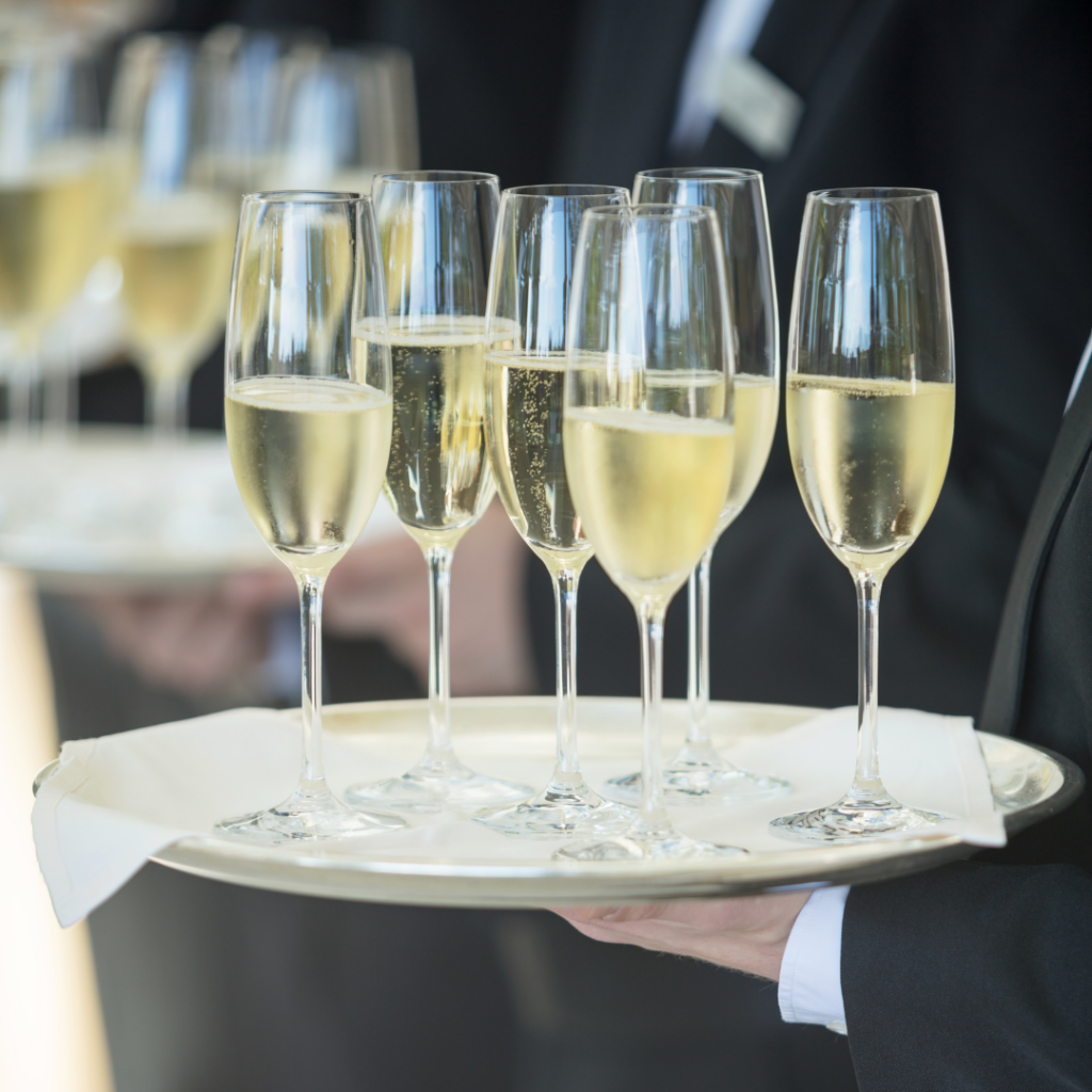 lit up waitresses holding champaign glasses on trays