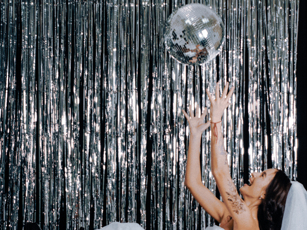 bride reaching for disco ball