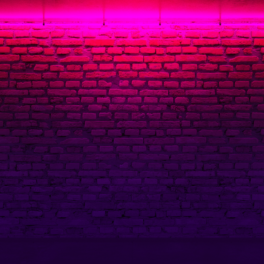 pink accent light lighting up a brick wall