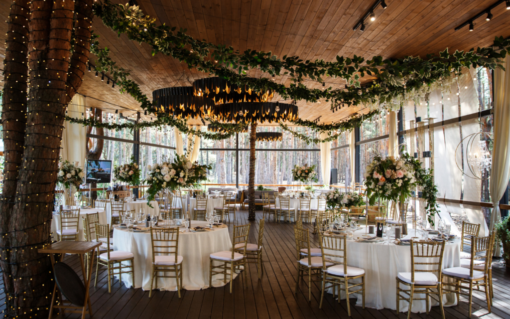 wedding reception with green plants and lighting decoration in the ceiling
