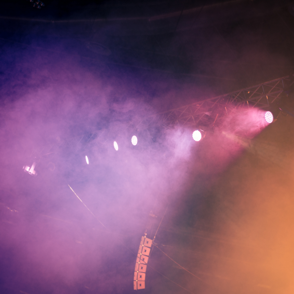 spotlights for stage in pink surrounded by smoke