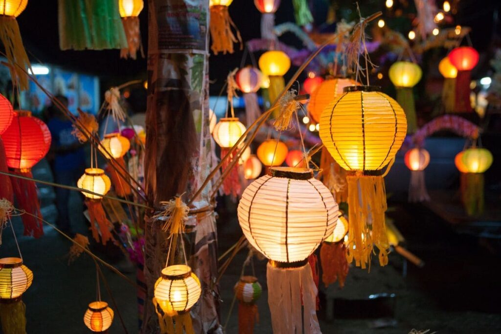 warm chinese style hanging lanterns lighting up the evening outside a wedding ceremony