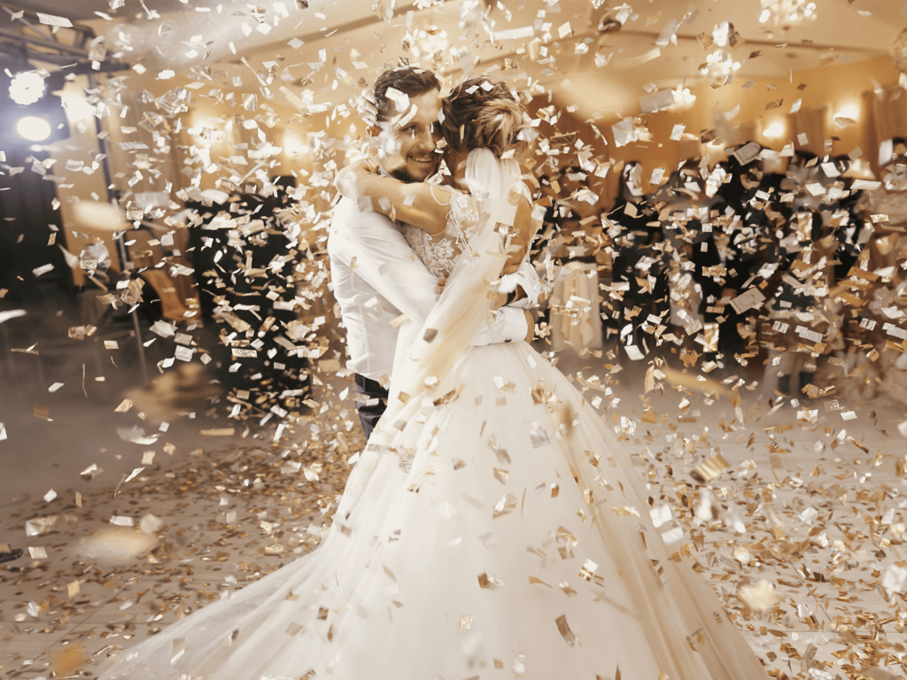 wedding couple dancing their first dance with confetti falling