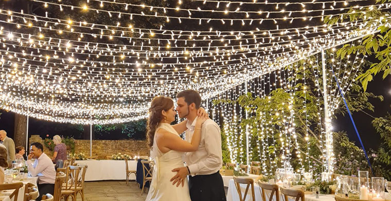 wedding couple first dance surrounded by fairy lights